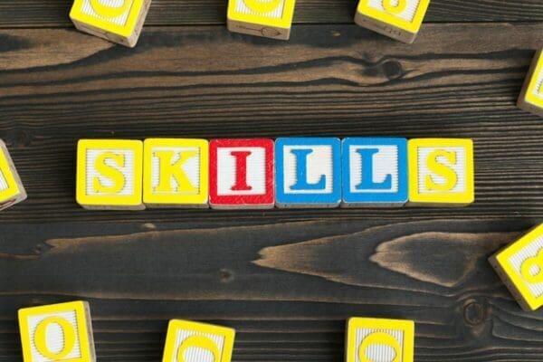 Skills spelled with alphabet blocks on a wooden table represents soft skills