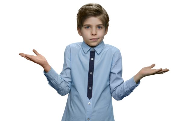 Confused boy giving I dont know gesture on white background