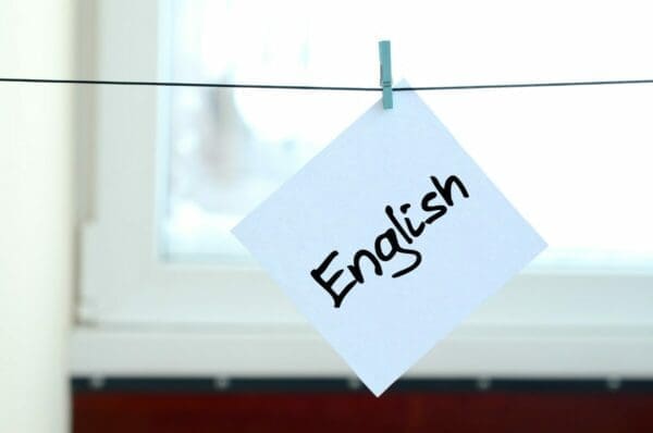 English written on note pinned to a line for Business English