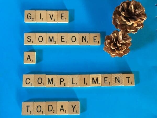 Give someone a compliment today quote on blue background