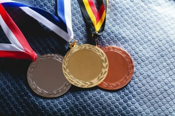 Gold, silver and bronze medal on velvet cushion
