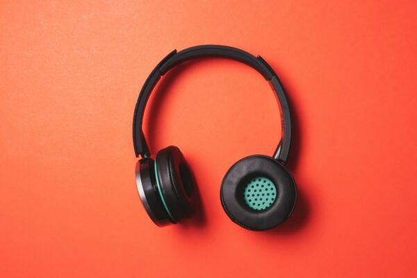 Modern headphones on a orange background.