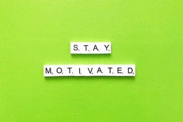 Stay motivated quote on green background