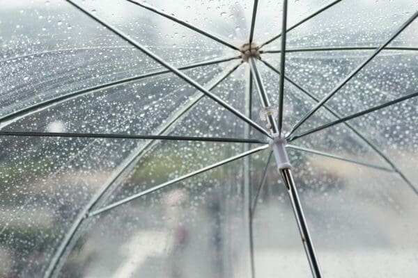 Transparent umbrella with raindrops covering it
