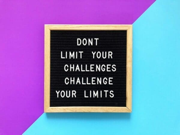 Don't limit your challenges challenge your limits quote on black board