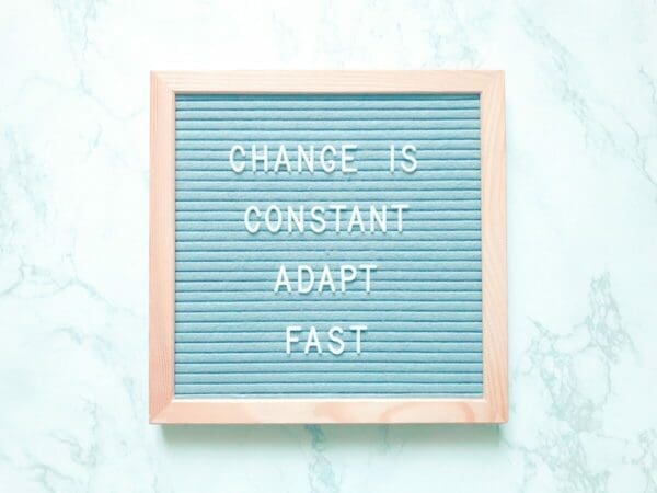 Change is constant Adapt fast quote on a blue felt board 