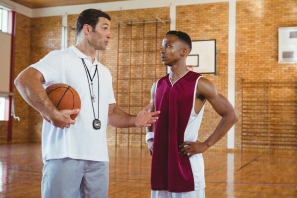 Coach guiding basketball player to make him great