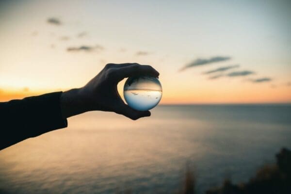 Glass ball with sea landscape in the background showing a clear focus image