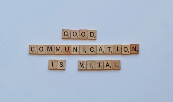 Good communication is vital spelled on wooden word scramble cubes