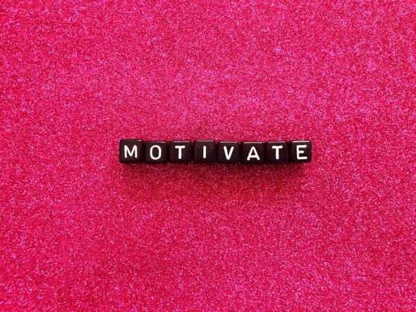 Motivate written in black cubes on pink background