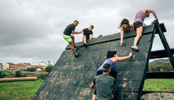 Participants in obstacle course climbing