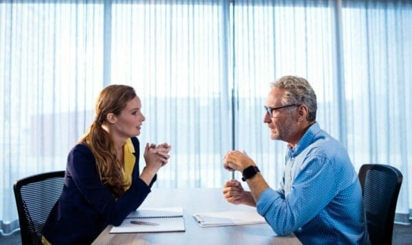 Two business people engaging in peer coaching