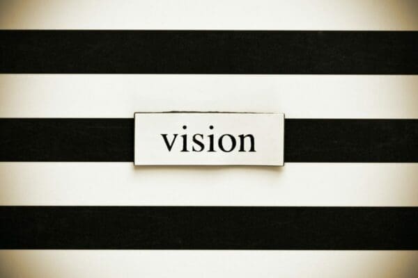 Vision label on black stripped background