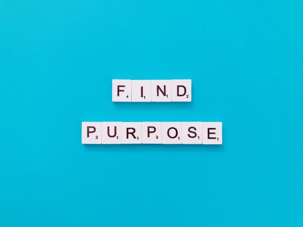 Find purpose spelt out in scrabble tiles on a blue background