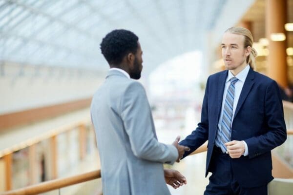 Two business partners handshaking during a negotiation