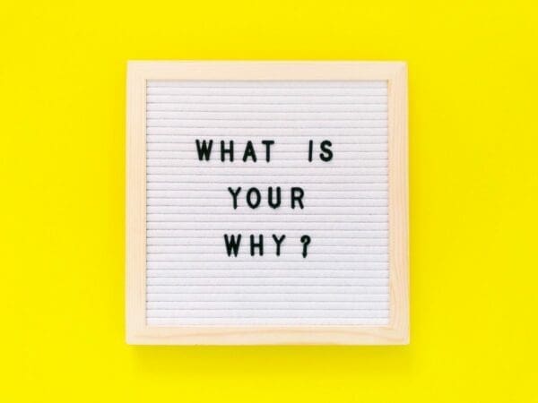 What is your why? quote written on felt board with yellow background
