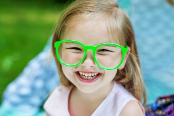 A little preschooler in green glasses