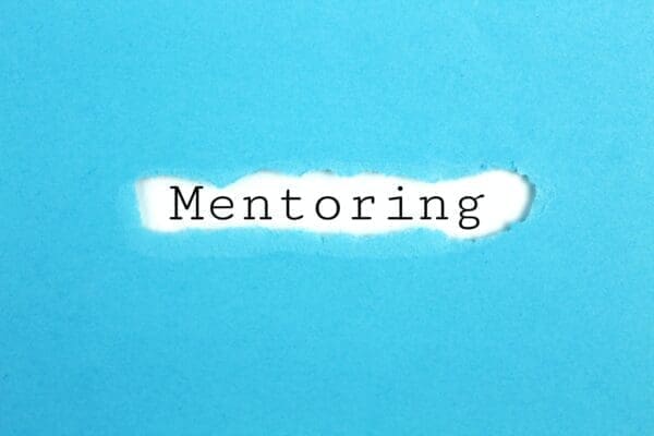 Mentoring on a torn paper with blue background