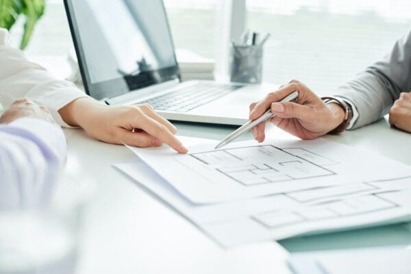Close-up of two businesspeople looking at a plan on paper