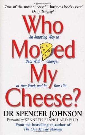 Book cover of Who Moved My Cheese by Spencer Johnson with red writing for a book review