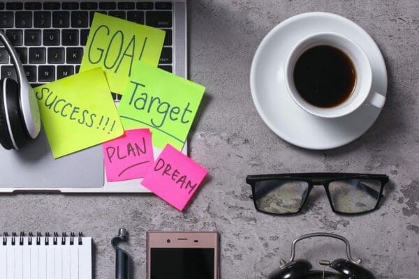 Business Motivation Quotes goal, success, plan, and dream stuck on a desk laptop 