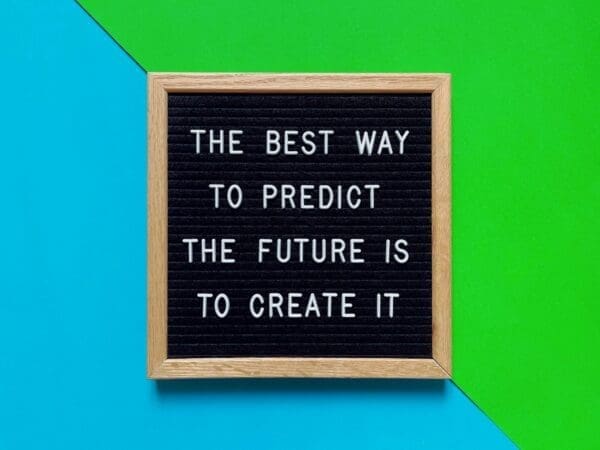 Future quote 'the best way to predict the future is to create it' on green and blue background