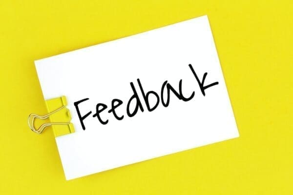 Feedback written on a clip note with a yellow background