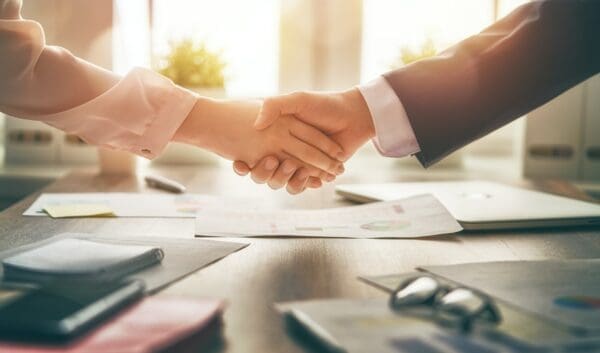 Two business people shaking hands in agreement after a negotiation