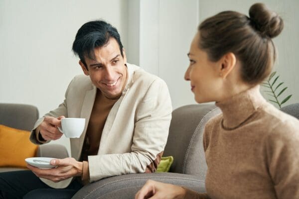 Male communicating with female over cup of coffee using transactional analysis