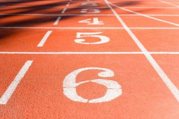 Numbers in white paint on a red running track