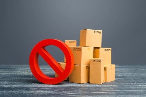 Cardboard boxes in a pile with a no entry sign in front
