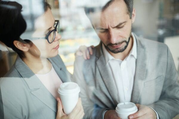 Female coworker showing Empathy to sad male coworker