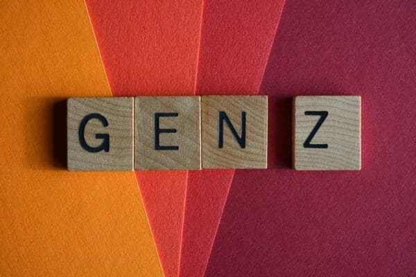 Gen Z for Zoomers spelled with wooden blocks on red and orange background
