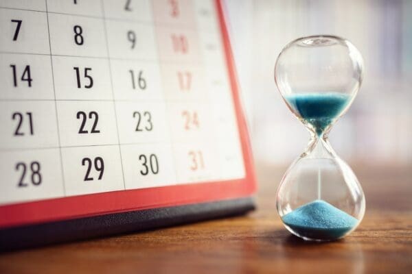 Hourglass and calendar represents calendar management for time management
