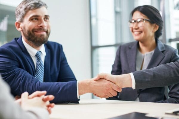 Businesspeople shaking hands after successful negotiation