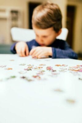 2 year old child solving jigsaw puzzle