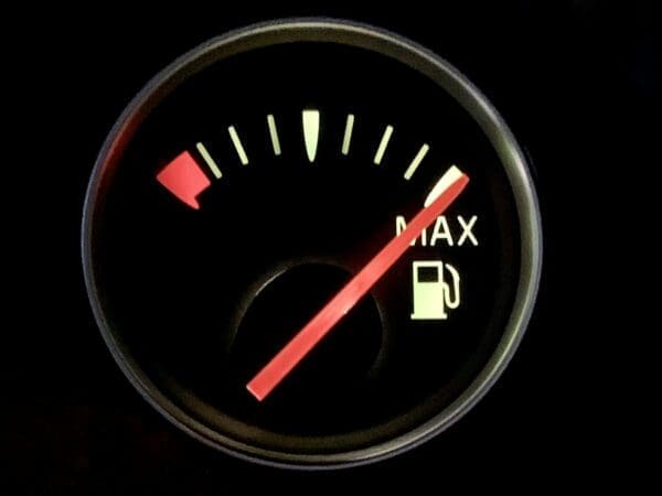 Closeup of car fuel gauge with the needle on maximum