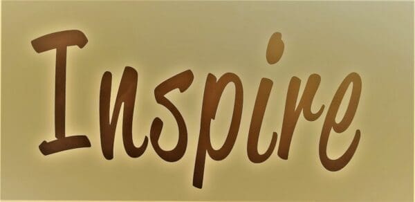 Inspire written in brown lettering on gold background