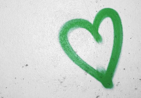Green heart drawing on a white wall