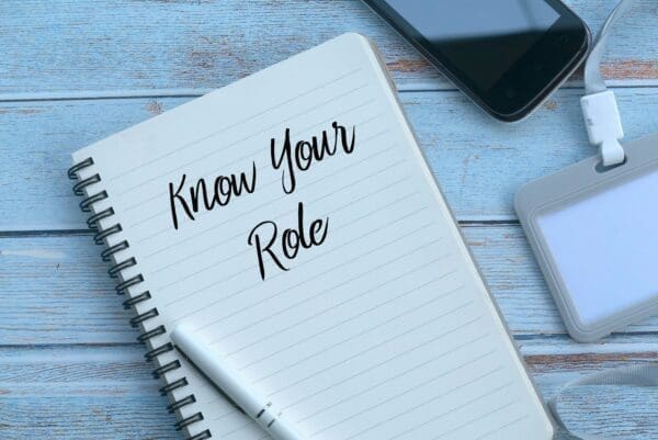 Know your role written on a lined pad next to a phone and pen