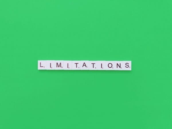 limitations spelled with word scramble cubes on green background