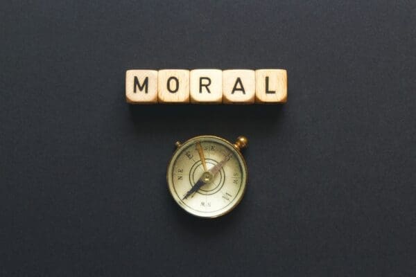 Moral spelled with cubes above a compass represents moral compass