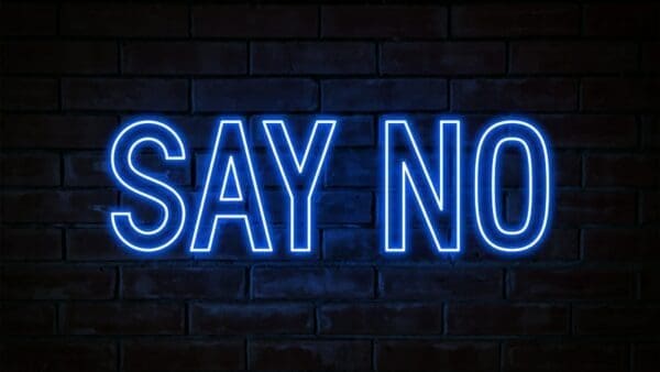 Say No blue neon light on brick wall background