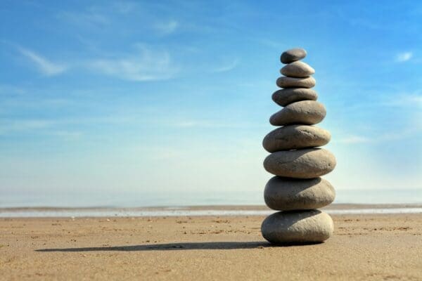 Stack of balanced stones with seashore background