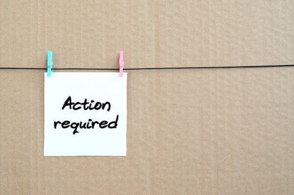 Action required written on post it note
