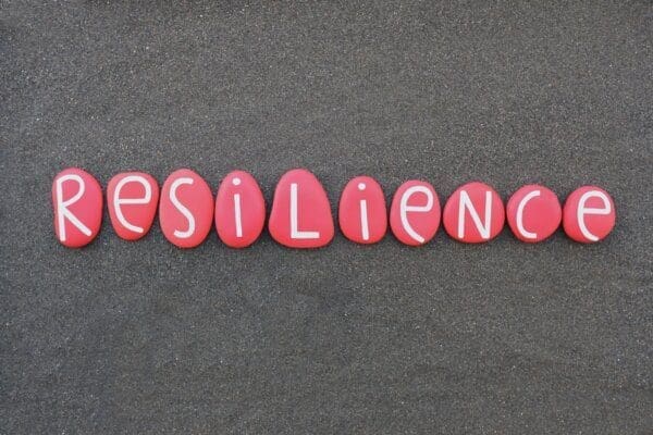 Resilience word composed with red colored stone letters