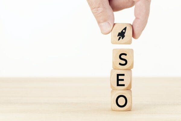 SEO and a rocket ship icon on wooden cubes