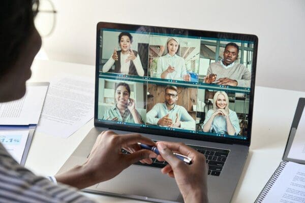Manager having virtual meeting with diverse business team