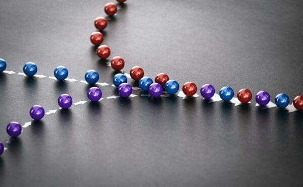 3 lines of marbles being streamlined into one line 