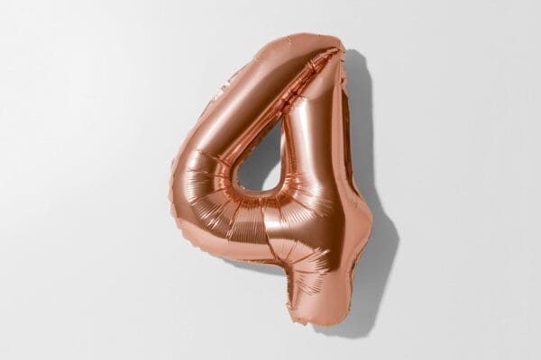 Number 4 Rose gold foil balloon on a white background 